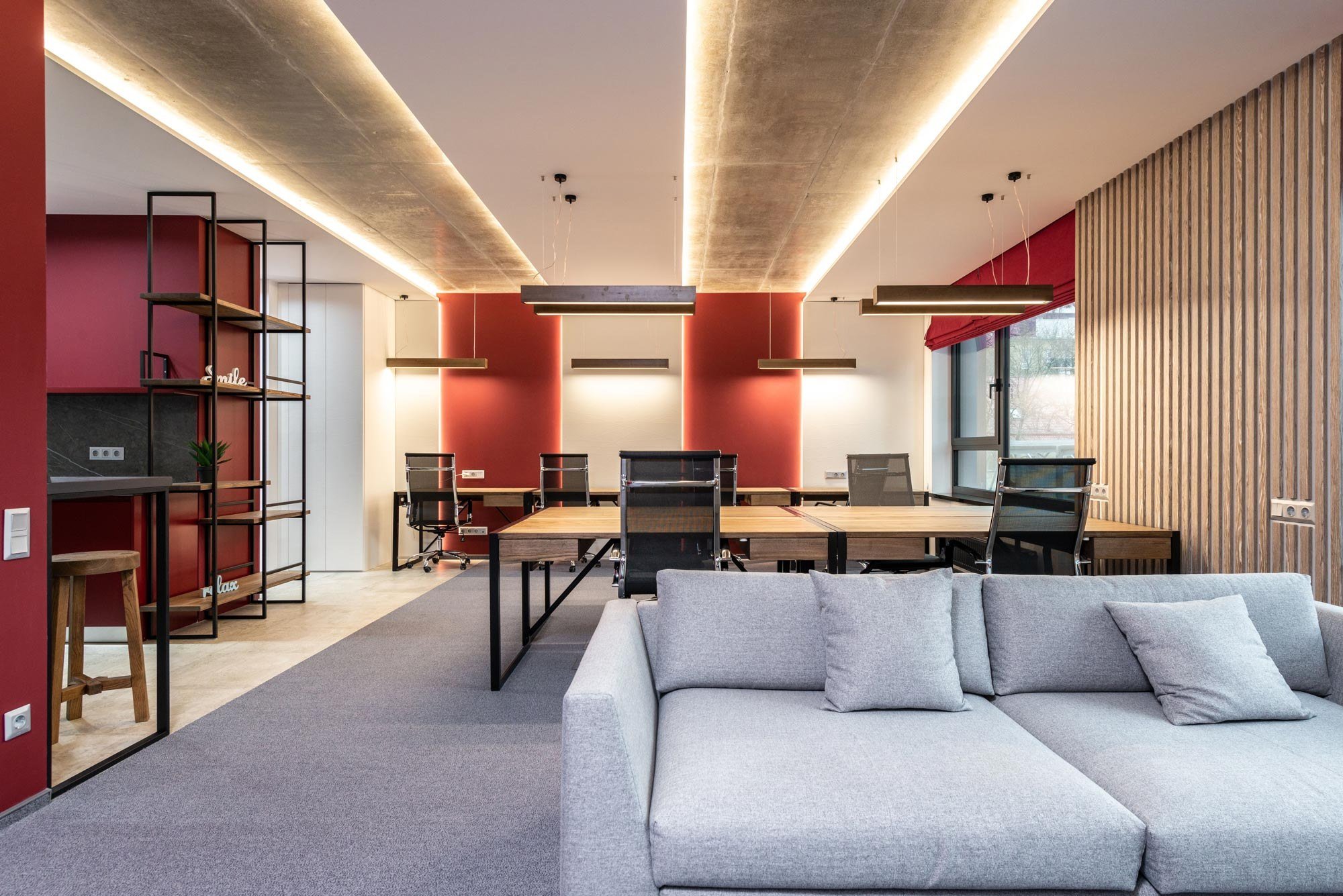 Open-plan office with desks and a lounge sofa