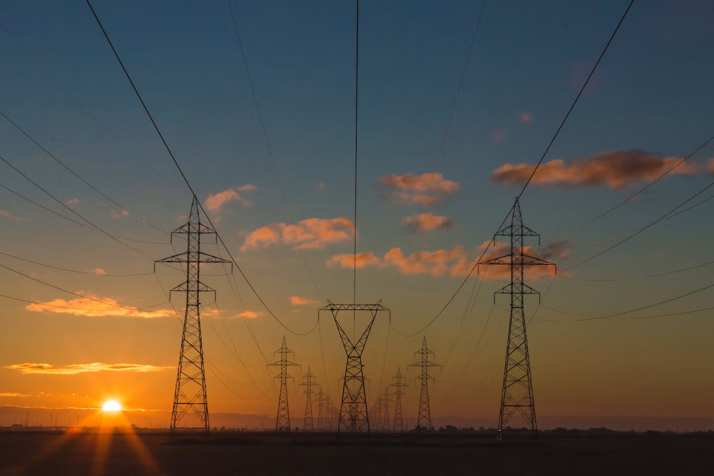 High-voltage transmission lines at sunset